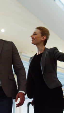 Business-people-interacting-on-an-escalator