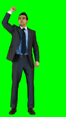 Businessman-gesturing-against-green-background