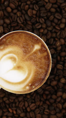 Close-up-of-coffee-cup-with-coffee-beans