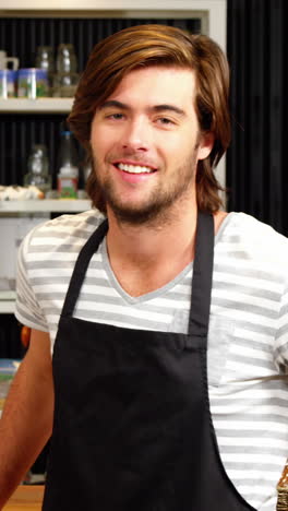 Male-waiter-cleaning-counter-with-a-rag