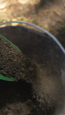 Close-up-of-gardner-using-trowel