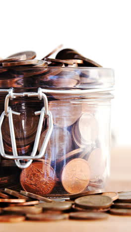 Close-up-of-coins-falling-in-bottle