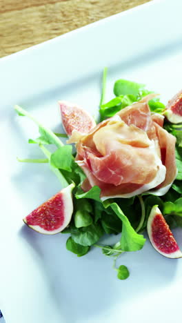 Salad-with-red-wine-on-wooden-table