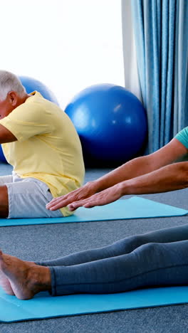 Senior-citizens-performing-stretching-exercise