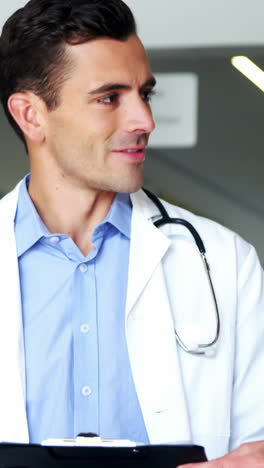 Mother-and-doctor-discussing-over-clipboard