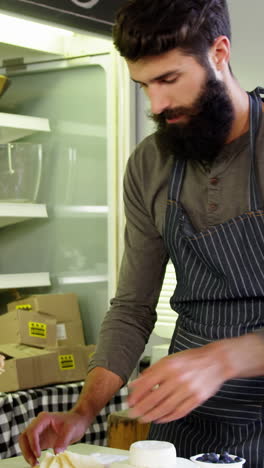 Man-standing-at-counter