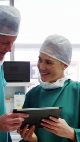 Doctor-and-colleague-discussing-over-digital-tablet