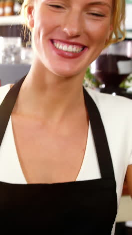 Portrait-of-waitress-making-cup-of-coffee-at-counter