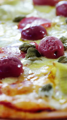 Baked-pizza-on-wooden-table