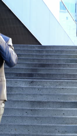 Businessman-with-a-diary-talking-on-mobile-phone-in-the-campus