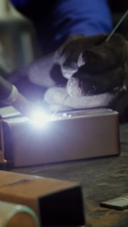 Male-welder-working-on-a-piece-of-metal