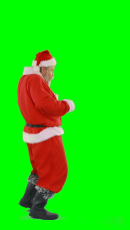 Santa-claus-dancing-against-green-background