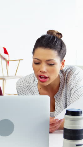 Photographer-and-female-model-discussing-over-laptop