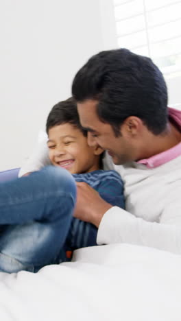 Father-and-son-playing-on-bed