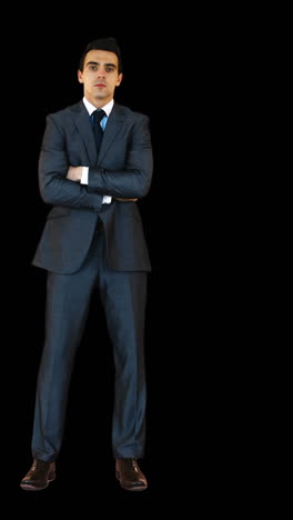 Young-businessman-standing-with-arms-crossed