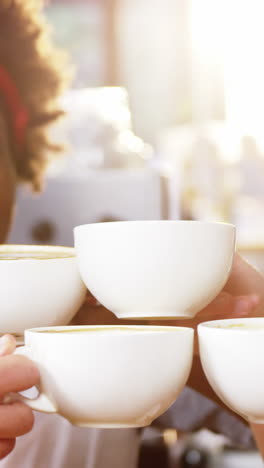 Group-of-happy-friends-holding-cup-of-coffee