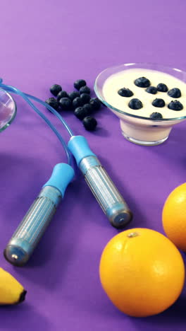 Dumbbells,-banana,-water-glass,-fruit,-skipping-rope-and-breakfast