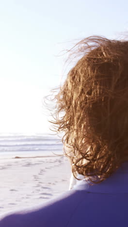 Surfer-standing-with-surfboard