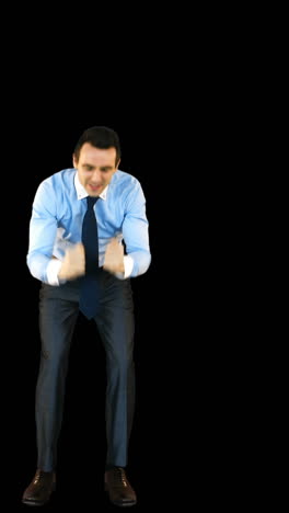 Excited-businessman-standing-against-black-background