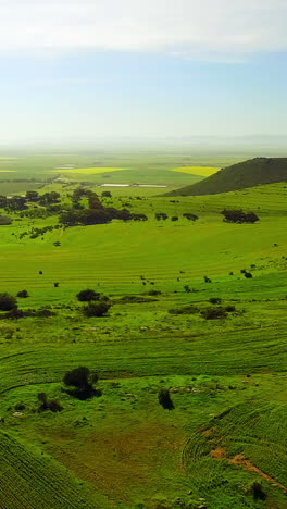 Aerial-view-of-a-dirt-road-winding-through-mountainous-terrain