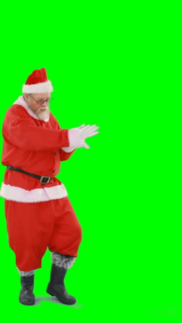 Santa-claus-dancing-against-green-background