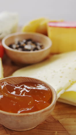 Different-types-of-cheese,-tomatoes-and-bowl-of-jam