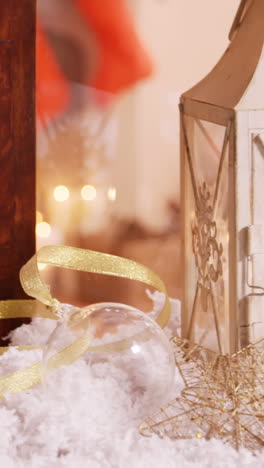 Pine-cone-and-lantern-decoration-on-fake-snow