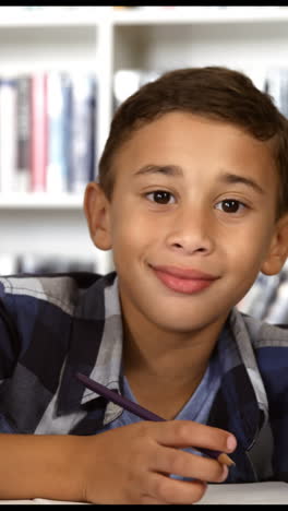 Schoolboy-studying-in-library