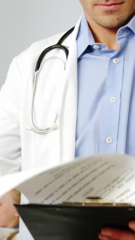 Doctor-examining-medical-report