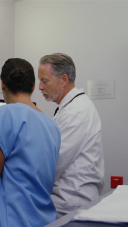 Surgeon-and-colleague-discussing-medical-reports