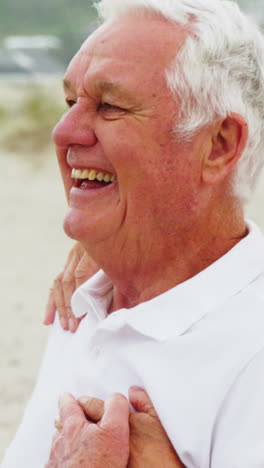 Senior-couple-embracing-each-other-on-the-beach