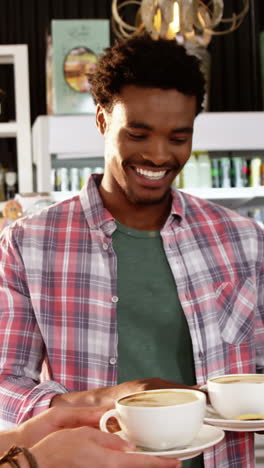 Waitress-serving-cup-of-coffee-to-customer