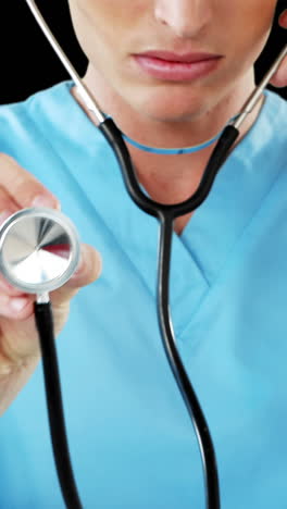 Close-up-of-male-surgeon-checking-with-stethoscope