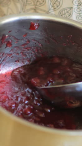 Mid-section-of-senior-woman-preparing-jam