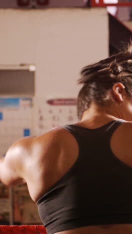 Tired-female-boxer-standing-in-the-ring