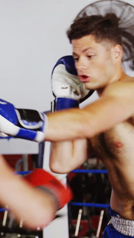 Two-boxers-practicing-in-boxing-ring