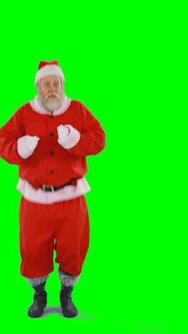 Santa-claus-dancing-against-green-background