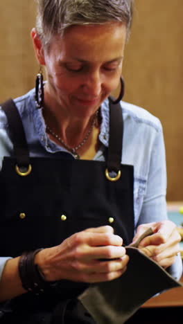 Craftswoman-working-on-a-piece-of-leather