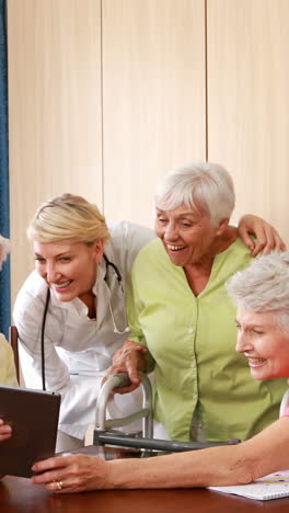 Female-doctor-interacting-with-senior-citizens