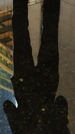 Reflection-of-a-businessman-in-the-puddle-using-digital-tablet