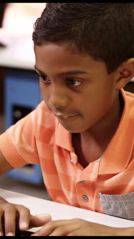 Schoolboy-studying-on-personal-computer-in-classroom