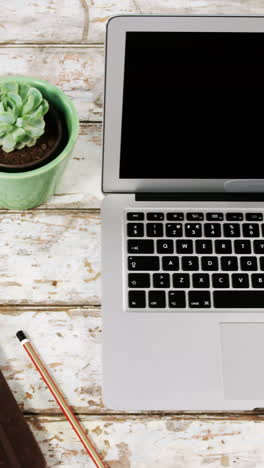 Laptop,-pot-plant,-diary-and-mobile-phone