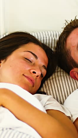 Couple-sleeping-in-bedroom