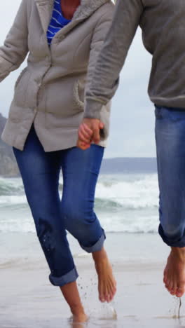 Mature-couple-enjoying-on-beach