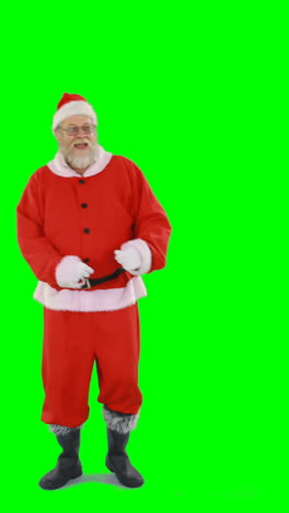 Santa-claus-dancing-against-green-background