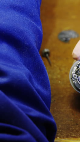 Close-up-of-horologist-hands-repairing-a-watch