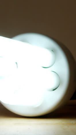 Close-up-of-bulb-glowing-on-a-table