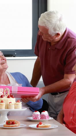 Senior-woman-receiving-gift-from-her-friend