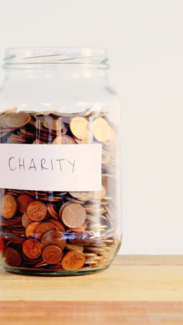 Close-up-of-coins-in-bottle-and-heart