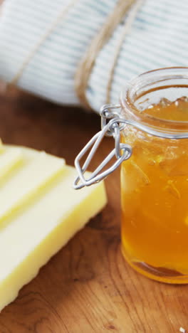 Bread-loaf-with-slices-of-cheese-and-sauce-on-wooden-serving-board